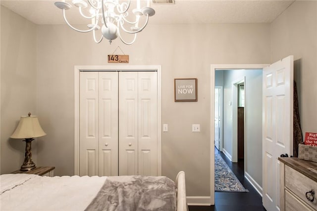 bedroom with a closet and a notable chandelier