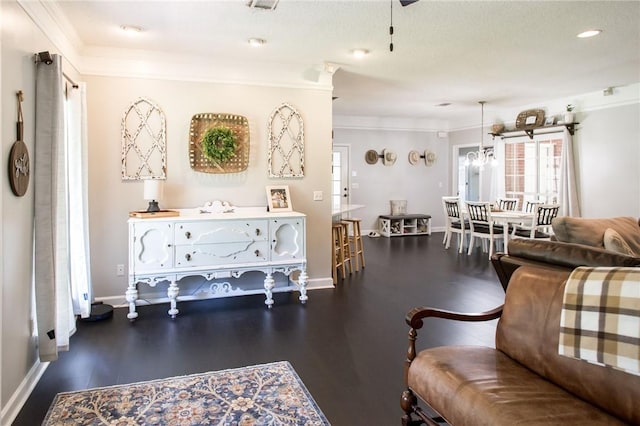 living room with dark wood-type flooring, crown molding, and an inviting chandelier