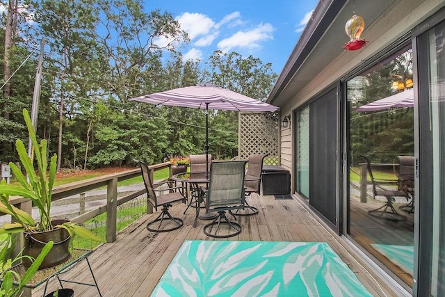1020 NE Pine Point Ln, Townsend, GA 31331 - wooden terrace with outdoor dining area