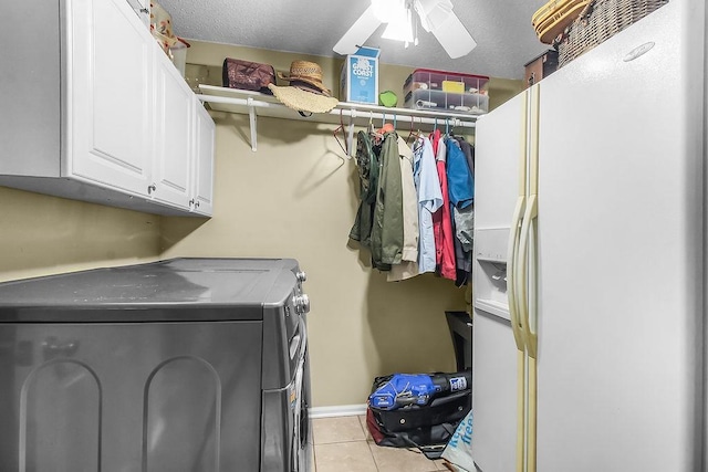 1020 NE Pine Point Ln, Townsend, GA 31331 - laundry area with washing machine and clothes dryer, cabinet space, light tile patterned floors, and ceiling fan
