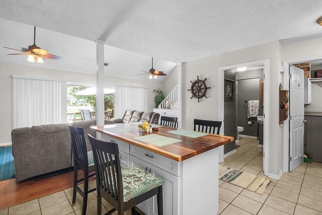 1020 NE Pine Point Ln, Townsend, GA 31331 - kitchen with wooden counters, ceiling fan, light tile patterned flooring, open floor plan, and a textured ceiling