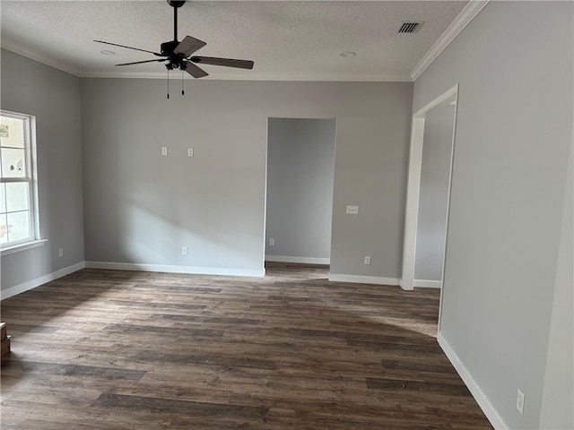 spare room featuring a textured ceiling, dark hardwood / wood-style flooring, ornamental molding, and ceiling fan