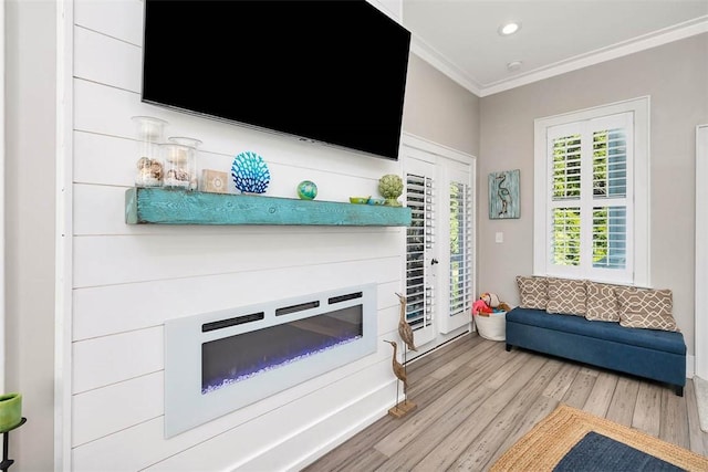 living room with light hardwood / wood-style flooring and ornamental molding