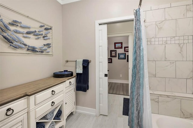 bathroom featuring hardwood / wood-style flooring and shower / tub combo