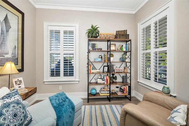 living area featuring crown molding, a healthy amount of sunlight, and hardwood / wood-style flooring