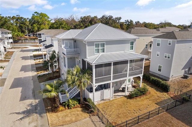 back of property with a sunroom