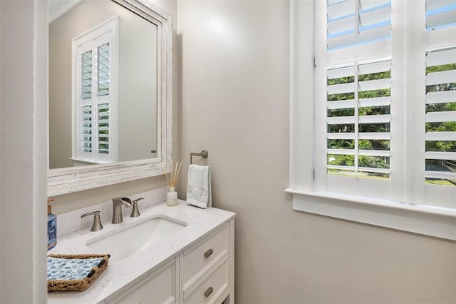 bathroom featuring a healthy amount of sunlight and vanity