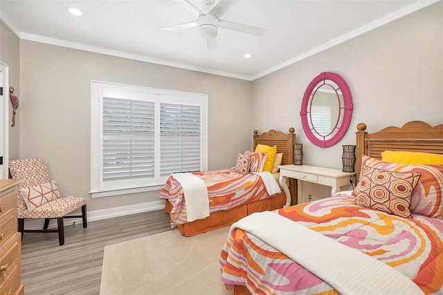 bedroom featuring crown molding, ceiling fan, and light hardwood / wood-style flooring