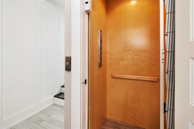 interior space featuring hardwood / wood-style flooring and elevator