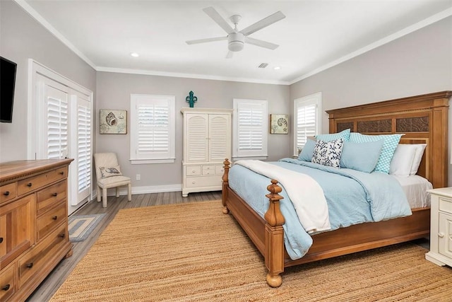 bedroom featuring ceiling fan, ornamental molding, multiple windows, and light wood-type flooring