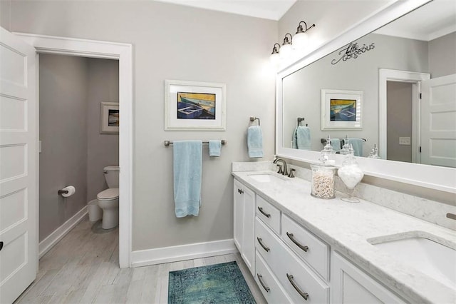 bathroom featuring hardwood / wood-style flooring, vanity, and toilet