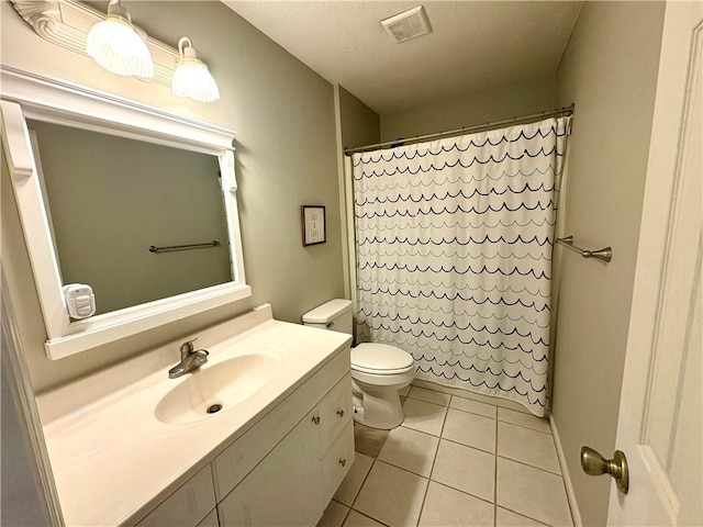 bathroom with visible vents, toilet, a shower with curtain, tile patterned floors, and vanity