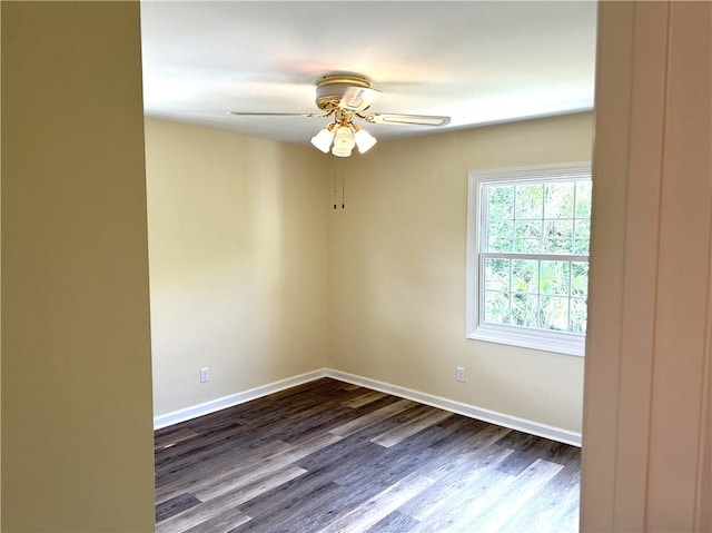 unfurnished room with ceiling fan and dark hardwood / wood-style flooring