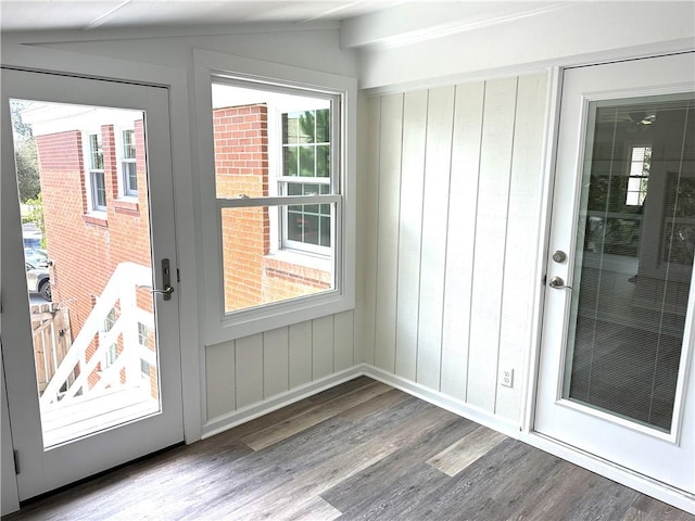 doorway to outside with hardwood / wood-style floors and lofted ceiling