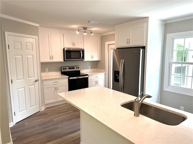 kitchen featuring sink, stainless steel appliances, dark hardwood / wood-style flooring, white cabinets, and ornamental molding