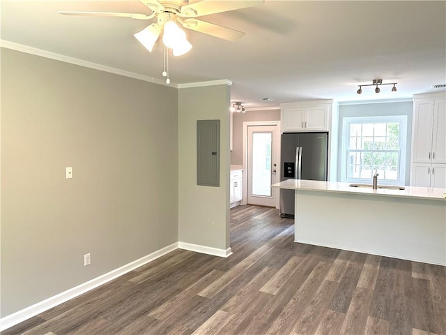 kitchen with ornamental molding, dark wood-type flooring, sink, white cabinets, and stainless steel fridge with ice dispenser