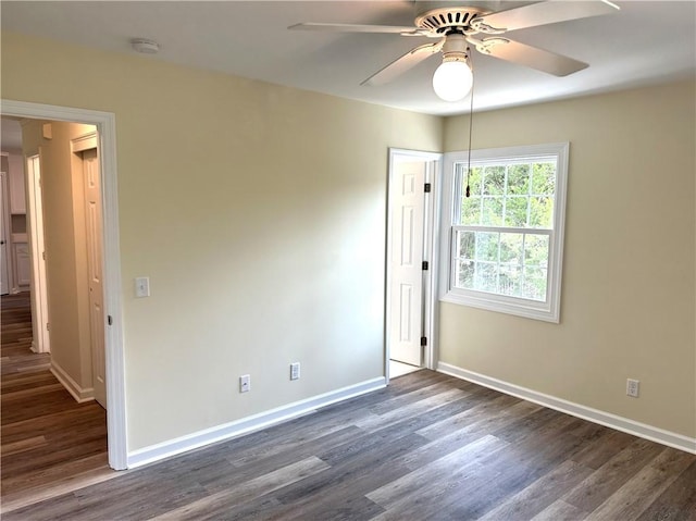 empty room featuring dark hardwood / wood-style floors and ceiling fan