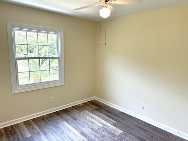 empty room with dark hardwood / wood-style floors and ceiling fan