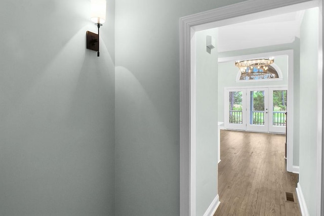 1079 Mayflower Rd NE Unit B, Townsend, GA 31331 - corridor featuring baseboards, a chandelier, and wood finished floors