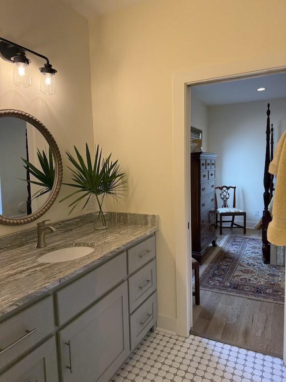 bathroom featuring baseboards, tile patterned floors, and vanity