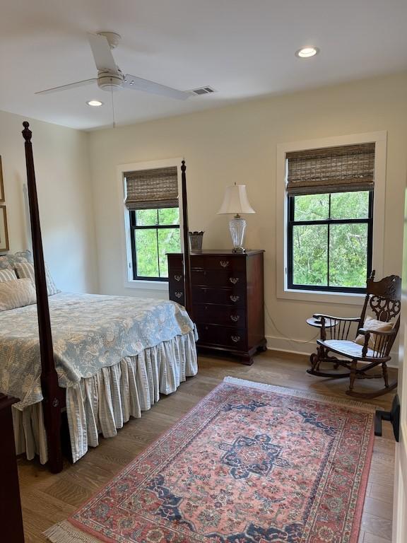 bedroom with recessed lighting, visible vents, and wood finished floors