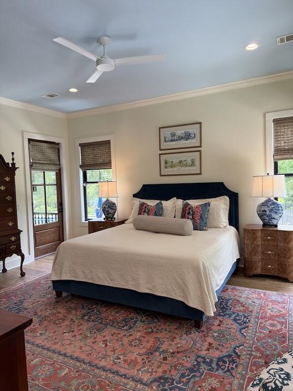 bedroom with ornamental molding, recessed lighting, visible vents, and wood finished floors