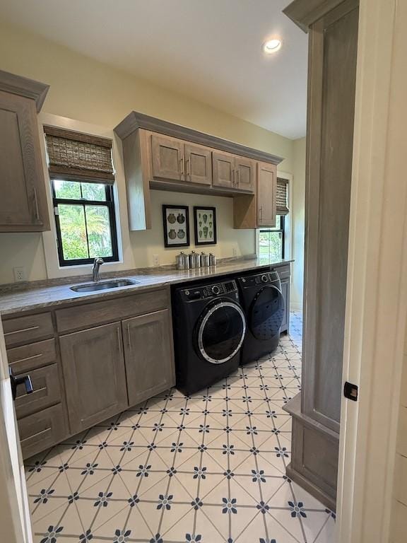 laundry area featuring a sink, cabinet space, light floors, recessed lighting, and washing machine and dryer