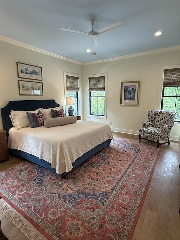 bedroom with ornamental molding, a ceiling fan, wood-type flooring, and recessed lighting