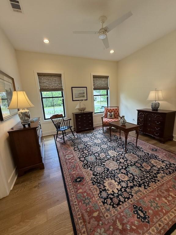 bedroom with recessed lighting, baseboards, visible vents, and wood finished floors