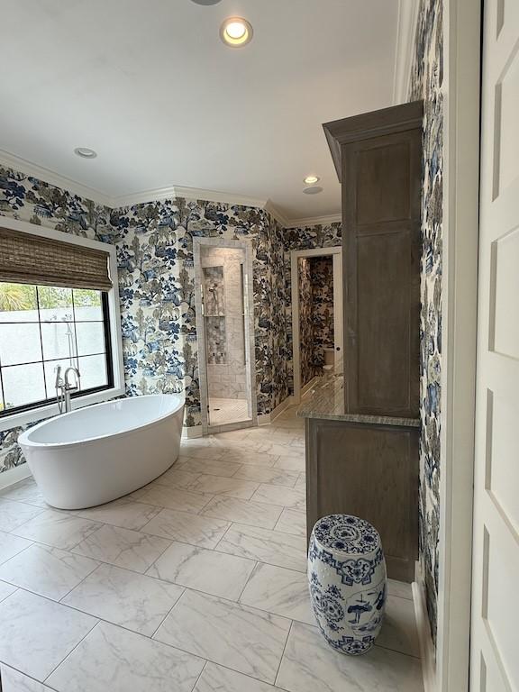 full bathroom with a shower stall, recessed lighting, a freestanding tub, and crown molding