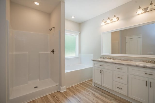 860 Kaitlyn Ave, Odum, GA 31555 - bathroom with wood-type flooring, vanity, and separate shower and tub