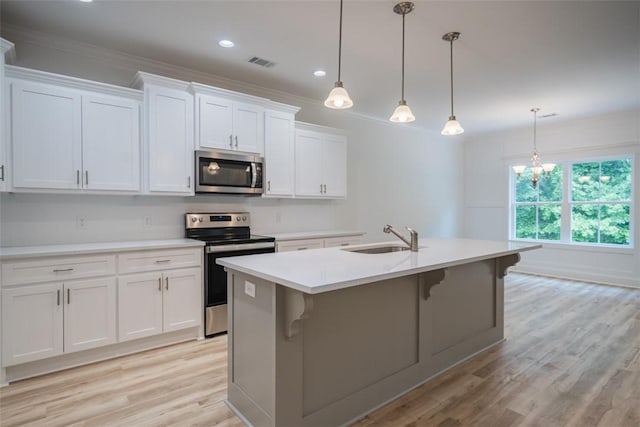 860 Kaitlyn Ave, Odum, GA 31555 - kitchen featuring white cabinetry, sink, pendant lighting, a kitchen island with sink, and appliances with stainless steel finishes