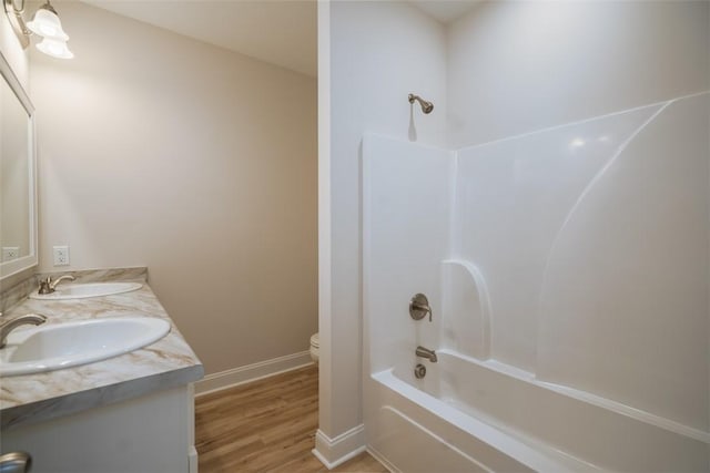 860 Kaitlyn Ave, Odum, GA 31555 - full bathroom with toilet, vanity,  shower combination, and hardwood / wood-style flooring