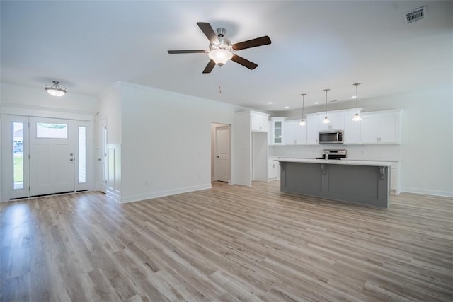 860 Kaitlyn Ave, Odum, GA 31555 - unfurnished living room with ceiling fan, light wood-type flooring, and ornamental molding