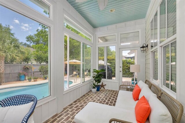 sunroom featuring ceiling fan and an outdoor hangout area