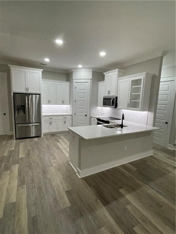 kitchen with white cabinets, decorative backsplash, sink, and appliances with stainless steel finishes