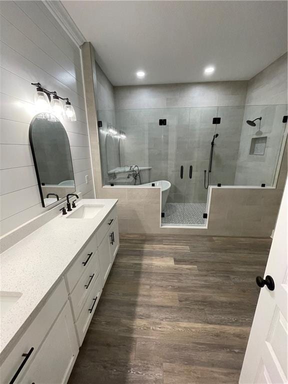 bathroom with wood-type flooring, vanity, and separate shower and tub