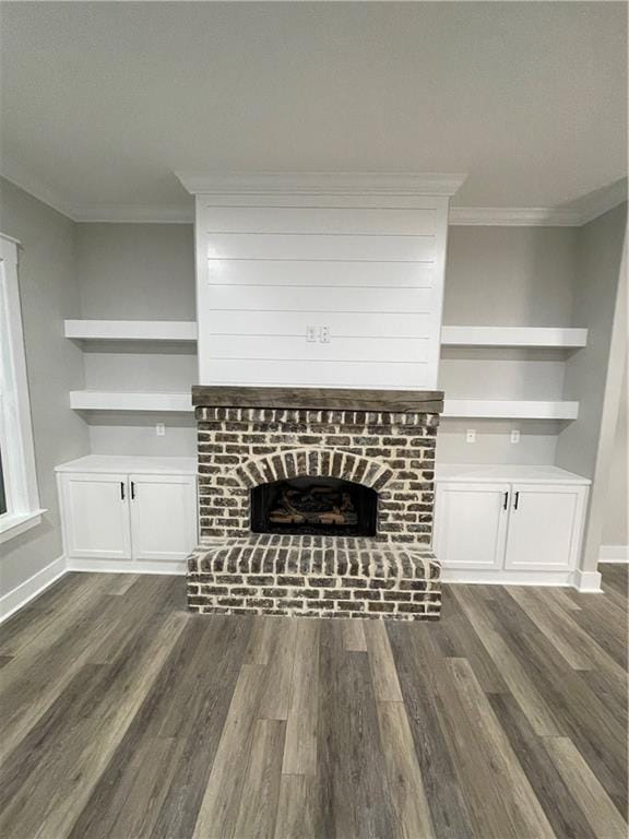 unfurnished living room with a fireplace, dark hardwood / wood-style flooring, and ornamental molding