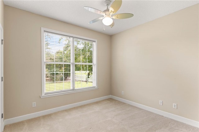 carpeted empty room with ceiling fan