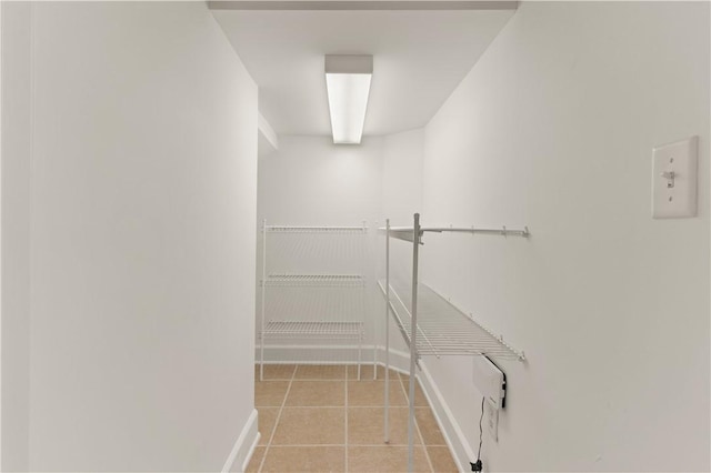 clothes washing area featuring light tile patterned floors