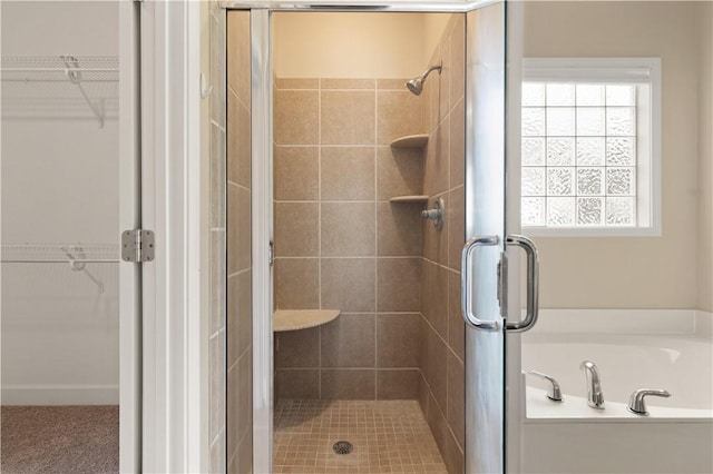 bathroom featuring a shower with door