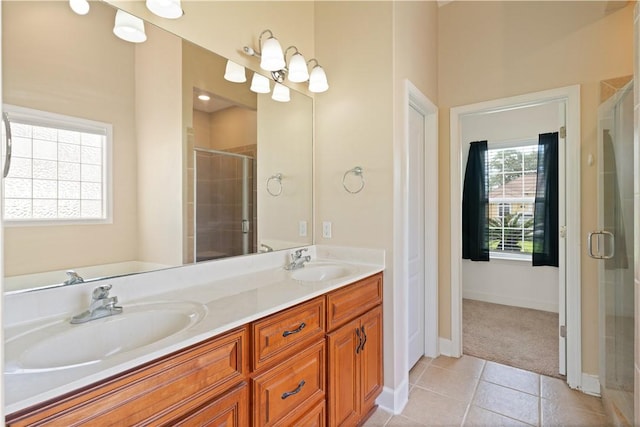 bathroom featuring tile patterned flooring, vanity, and a shower with shower door