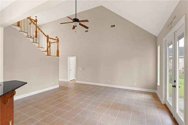 unfurnished living room with ceiling fan, french doors, high vaulted ceiling, and tile patterned flooring