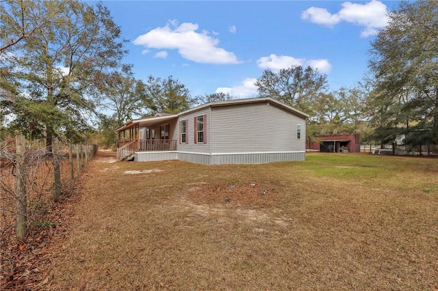 view of side of property with a yard and a porch