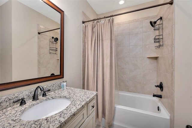 bathroom featuring vanity and shower / bath combo with shower curtain