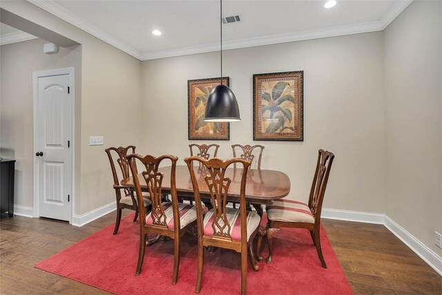 dining room with crown molding and dark hardwood / wood-style flooring