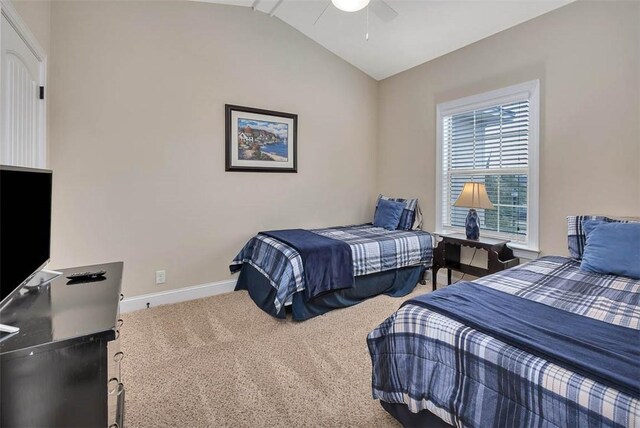 carpeted bedroom with vaulted ceiling and ceiling fan