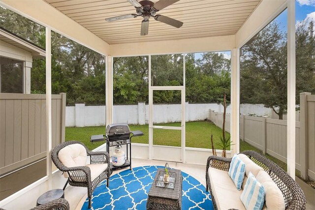 sunroom with wood ceiling and ceiling fan