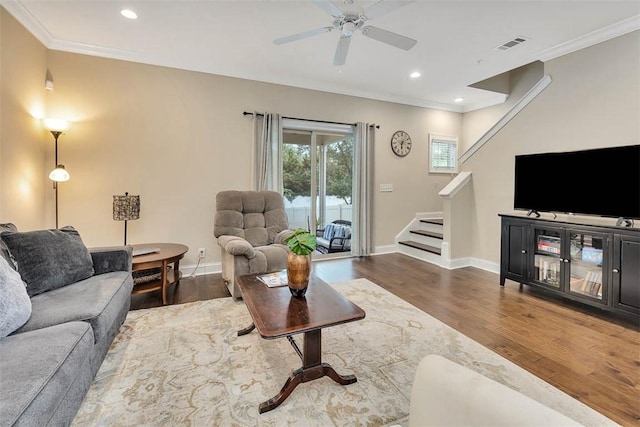 living room featuring crown molding, ceiling fan, and dark hardwood / wood-style floors