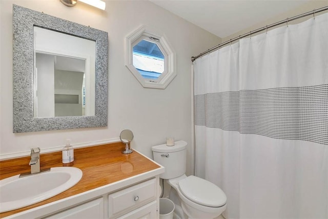 bathroom with toilet and vanity